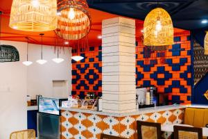 a restaurant with colorful walls and chandeliers at Bila Boutique Hotel in Lagao II