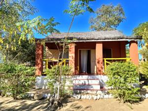a red house in the middle of trees at Ecolodge d'Isalo in Ranohira