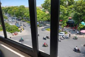 a view from a window of people riding motorcycles at YÊN HÒA MOTEL in Hanoi +42 photos