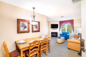 a dining room and living room with a table and chairs at Vacation Village in the Berkshires in Hancock
