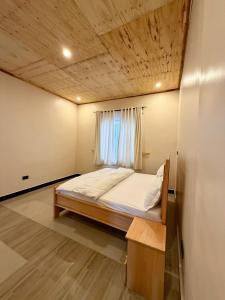 a bedroom with a bed and a window at JND Cozy Homes in Iringa