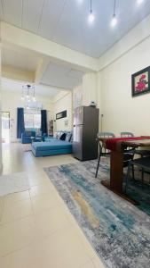 a living room with a table and a blue couch at Baan Mali one in Hua Hin