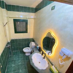 a bathroom with a sink and a toilet at Jme Bunks Hostel in Aswān