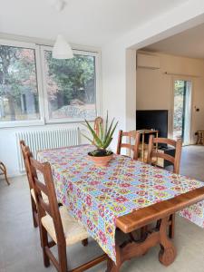 a dining room with a table with a plant on it at Villetta Brasi in Celle Ligure