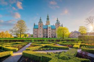 a large building with a garden in front of it at PENDING Queen Bedroom with Balcony in Shared Apartment in Copenhagen