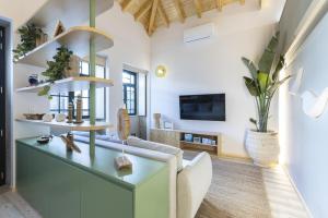 a living room with a couch and a tv at Lobo do Mar in Viana do Castelo