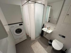 a bathroom with a washing machine and a sink at PENDING Queen Bedroom with Balcony in Shared Apartment in Copenhagen +37 photos