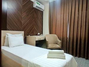 a bedroom with a bed and a chair and a desk at ORZU HOTEL in Namangan +24 photos
