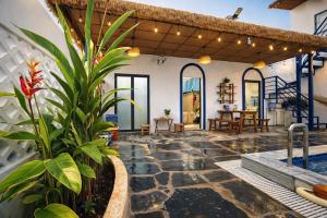 a house with a swimming pool and a patio at Doc Bien Homestay Mui Ne - Entire Home in Ấp Khánh Phước (1)