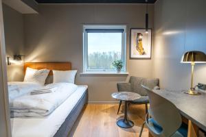 a hotel room with a bed and a window at MyHotel Taastrup in Tåstrup
