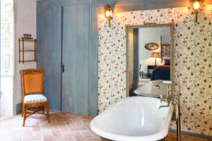 a bathroom with a tub and a chair and a mirror at Convento de Cabanas in Viana do Castelo +93 photos
