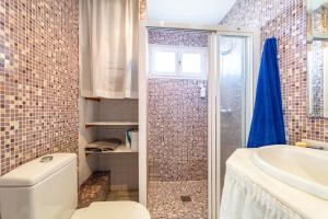 a bathroom with a toilet and a sink and a shower at Atlantic View Apartment-El Rompido in El Rompido +18 photos