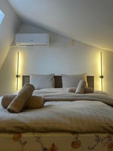 a bedroom with a large bed with two pillows at Velvet Alps Bovec in Bovec