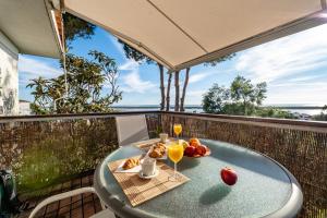 a table with food and drinks on a balcony at Atlantic View Apartment-El Rompido in El Rompido