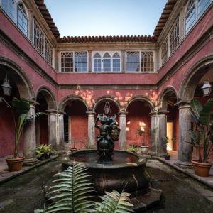 a courtyard with a fountain in a building at Convento de Cabanas in Viana do Castelo