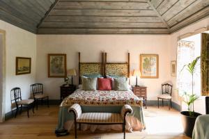 a bedroom with a large bed with a wooden ceiling at Convento de Cabanas in Viana do Castelo