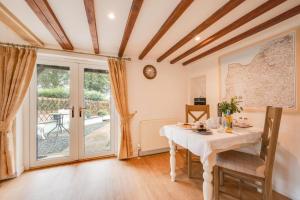 a dining room with a table and a window at 1 Bed in West Putford oc-thymw in Bulkworthy