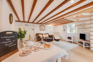 a living room with a table with food on it at 1 Bed in West Putford oc-thymw in Bulkworthy