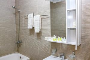 a bathroom with a shower and a toilet and a sink at ORZU HOTEL in Namangan