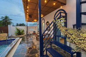 a staircase leading up to a house with a swimming pool at Doc Bien Homestay Mui Ne - Entire Home in Ấp Khánh Phước (1)