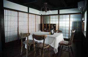 a dining room with a table and four chairs at 里の宿 門後藤 in Taketa