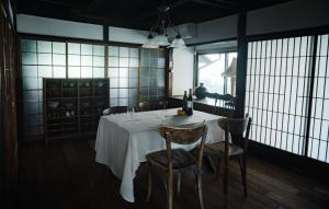 a dining room with a white table and chairs at 里の宿 門後藤 in Taketa +48 photos