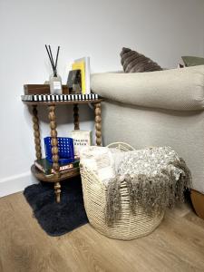 a room with a basket and a table with books at Rosern Short Stays in St. Ives