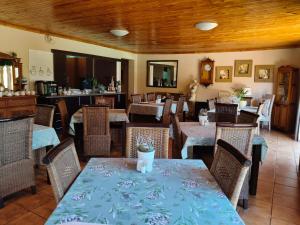 a restaurant with tables and chairs in a room at Acacia Gastehuis in Kathu