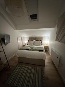 a bedroom with a bed and a rug at Rosern Short Stays in St. Ives +6 photos