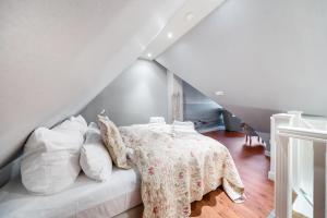 a bedroom with a bed with a table and pillows at Fernsicht in Morsum