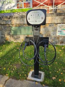 a gas pump with a sign on the grass at Hotel Děčín Na Skřivánce in Děčín