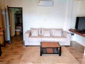a living room with a white couch and a coffee table at Baan View Talay Pool Villas in Thong Nai Pan Yai