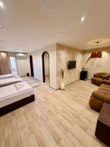 a large room with two beds and a flat screen tv at Solima pyramids inn in Cairo