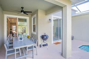 a dining room with a table and a ceiling fan at Stunning 4BR at ChampionsGate - Pool & BBQ in Kissimmee