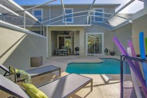 a living room with a swimming pool and a house at Stunning 4BR at ChampionsGate - Pool & BBQ in Kissimmee +88 photos