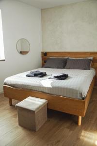 a bedroom with a large bed with a wooden frame at Casa Al Castagneto in Ceniga