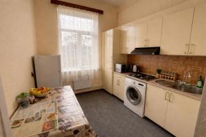 a kitchen with a sink and a dishwasher at 5 minute from Airport Baku in Bina +9 photos