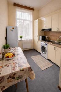 a kitchen with a table with a bowl of fruit on it at 5 minute from Airport Baku in Bina