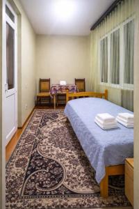 a bedroom with a bed and a rug at 5 minute from Airport Baku in Bina