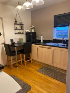 a kitchen with a table and chairs and a sink at Gramhor House in Dumfries