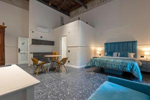 a bedroom with a bed and a table and chairs at Il Tesoro Smart Suite & SPA in Naples