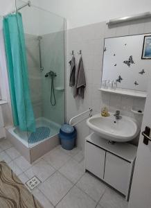 a bathroom with a shower and a sink at Hotel Béke Sziget Komló in Komló +54 photos