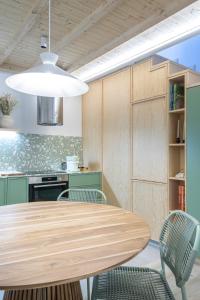 a kitchen with a wooden table and chairs at Lobo do Mar in Viana do Castelo