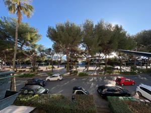 a parking lot with cars parked in a lot with trees at Casa Lungomare in Arenzano