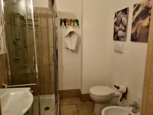 a bathroom with a shower and a toilet and a sink at B & B Stella Marina in Taranto +14 photos