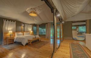 a bedroom with a bed in a tent at Olesamara Collection in Nanyuki +93 photos