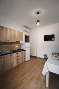 a kitchen with a white refrigerator and a table at La Chianconata- Casa vacanze a Vieste in Vieste