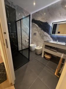a bathroom with a shower and a toilet and a sink at Casa Lo Bianco in Terrasini +22 photos