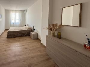 a bedroom with a bed and a mirror on the wall at Casa Lo Bianco in Terrasini