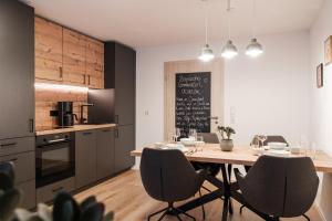a kitchen and dining room with a table and chairs at Ferienwohnung Beim Paschamarte in Schwangau